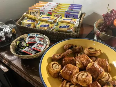a table topped with a plate of pastries and snacks at Bower House Inn in Eskdale