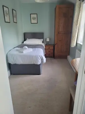 a bedroom with a bed and a wooden door at Bower House Inn in Eskdale
