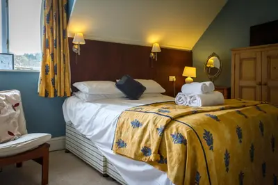 a hotel room with a bed with towels on it at Stanley House in Eskdale