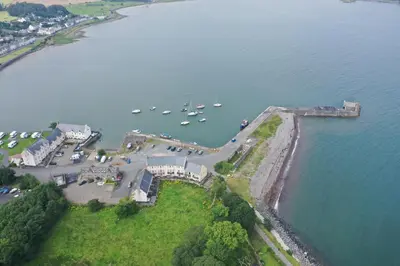 an aerial view of a harbor with boats in the water at Cladach in Garlieston