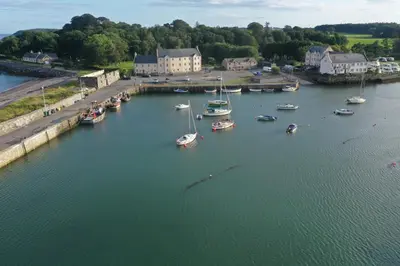 an aerial view of a harbor with boats in the water at Cladach in Garlieston