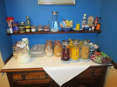 a kitchen counter with jars of food and drinks at Brookfield B&B Guest House in Keswick