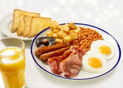 a plate of breakfast food with eggs bacon beans and toast at Days Inn Lockerbie - Annandale Water in Johnstonebridge