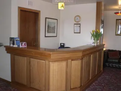 a wooden reception counter in a room with at Solway Lodge Hotel in Gretna Green