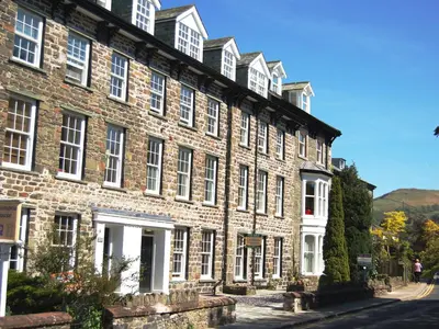 a large brick building with white windows on a street at Chaucers Nook in Keswick