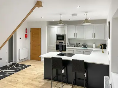 a kitchen with white cabinets and a white counter top at Causey View in Keswick