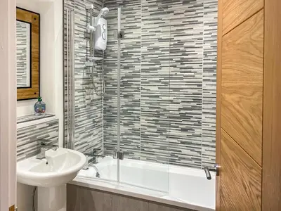 a bathroom with a sink and a glass shower at Causey View in Keswick