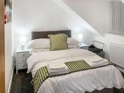 a bedroom with a bed and a nightstand with two lamps at Causey View in Keswick