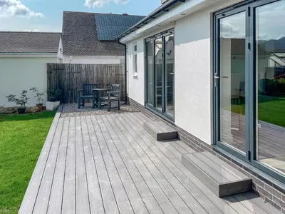 a wooden deck with a table and chairs on it at Causey View in Keswick