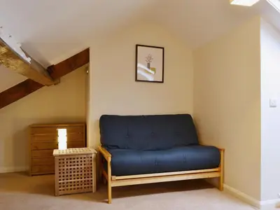 a blue couch sitting in the corner of a room at Beny Cot in Keswick