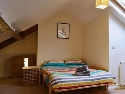 a bedroom with a bed with towels on it at Beny Cot in Keswick