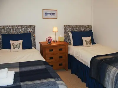 two beds in a room with blue and white at Blencathra in Mungrisdale
