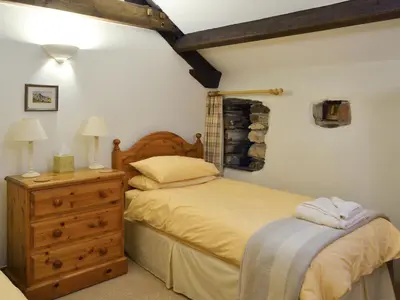 a bedroom with a bed and a dresser at The Garth in Mungrisdale