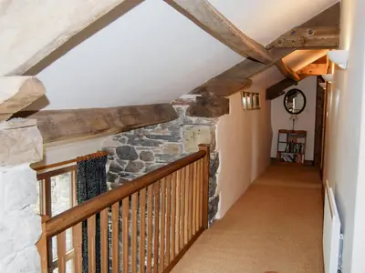 a hallway in a house with a stone wall at The Garth in Mungrisdale