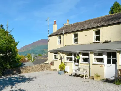 a house with a bench in front of it at Harriet's Hideaway in Braithwaite