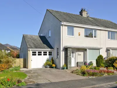 a white house with a white garage at Heatherside in Portinscale