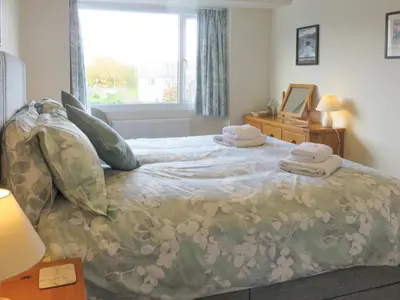 a bedroom with a bed with towels on it at Heatherside in Portinscale