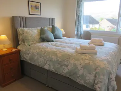 a bedroom with a bed with towels on it at Heatherside in Portinscale