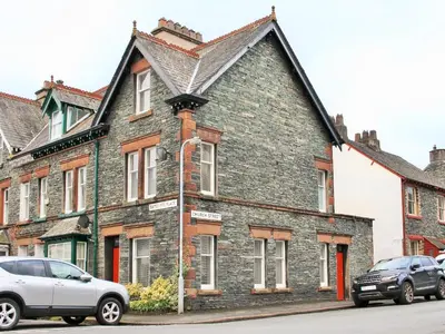 an old brick house with a car parked in front of it at Oak Lea in Keswick