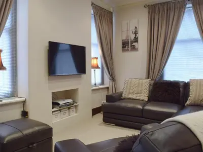 a living room with a couch and a flat screen tv at Oak Lea in Keswick