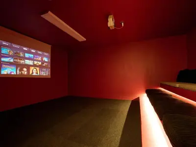 a red room with a couch and a tv at Fell View in Troutbeck