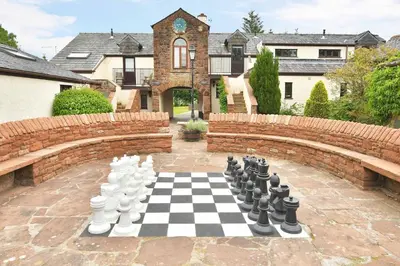 a chess board on a patio with a brick wall at Fell View in Troutbeck