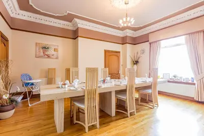 a dining room with a large table and chairs at Thornbank House in Stranraer