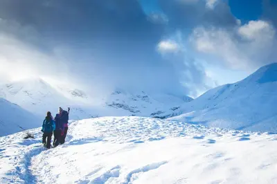a group of people standing on top of a snow covered mountain at The Mount B&B in Keswick