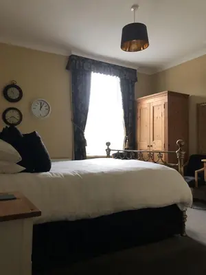 a bedroom with a large bed and a window at Glendale Guest House in Keswick