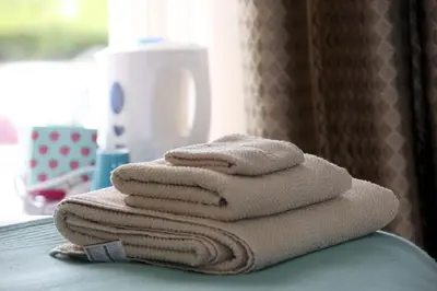 a stack of towels sitting on top of a counter at Crofthead Farm House in Tarbolton