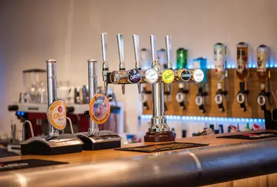 a bar with a row of wine glasses on a counter at Mannin Hotel in Douglas
