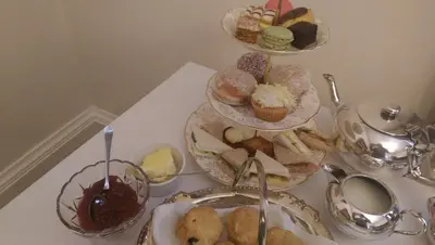a table topped with plates of pastries and desserts at Lochinver Guesthouse in Ayr