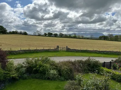 a field with a fence in the middle of a yard at Ann's Hill in Cockermouth