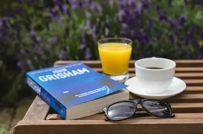 a book and a cup of coffee and a glass of orange juice at Ann's Hill in Cockermouth
