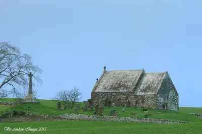 an old stone church on a hill with a cross at Crailloch Croft Cottages in Stranraer
