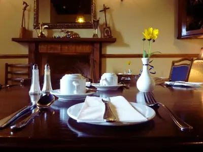 a table with plates and utensils on top of it at The Douglas Hotel in Langholm