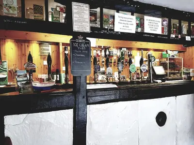 a bar with a sign in front of it at The Old Dungeon Ghyll Hotel in Great Langdale