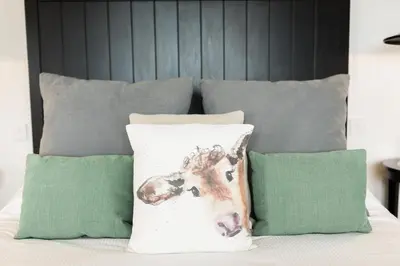 a group of pillows sitting on a bed at Sea View Snugs at Laggan in Gatehouse of Fleet