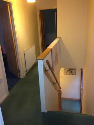 a hallway with a staircase in a room at House for Groups & Contractors Kilmarnock in Kilmarnock