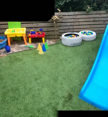 a playground with several play equipment on the grass at Lulus in St Bees