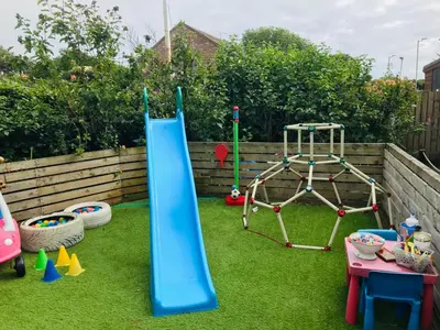 a playground with a slide and a play set at Lulus in St Bees