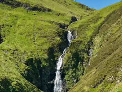 a waterfall on the side of a mountain at Roseburn Cottage in Moffat