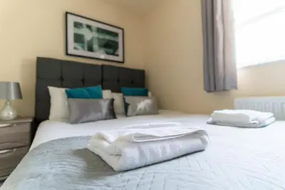 a bedroom with a bed with towels on it at Church View Irene Court Cockermouth in Cockermouth