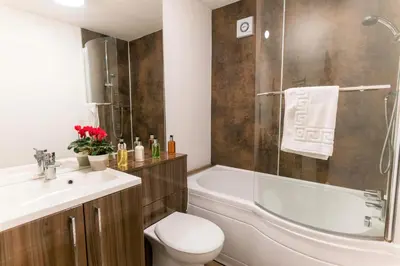 a bathroom with a toilet and a sink and a shower at Church View Irene Court Cockermouth in Cockermouth