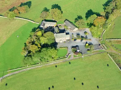 an aerial view of a large house in a field at Saddleback Barn in Penrith