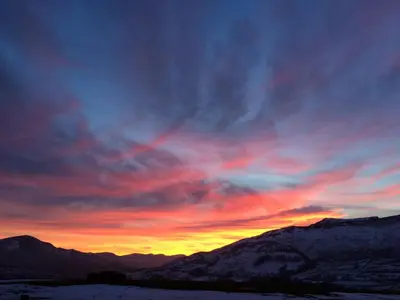 a sunset in the mountains with the sky at Stable Barn in Penrith