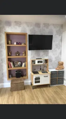 a kitchen with a stove and a tv on a wall at Ancrum House in Gretna Green
