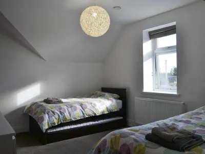 a bedroom with two beds and a window at Ancrum House in Gretna Green