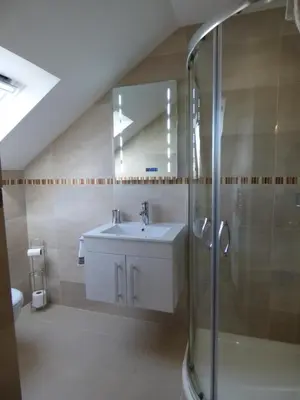 a bathroom with a sink and a shower at Cairndoon Byre in Monreith