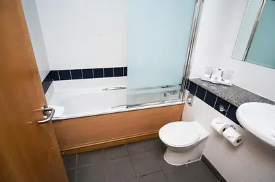 a bathroom with a shower and a toilet and a sink at The Park Hotel in Kilmarnock